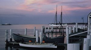 Martha's Vineyard harbor at sunset docks and boat