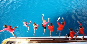 Bleisure Travel for the Millennial Work force Lady J - family jumping off boat