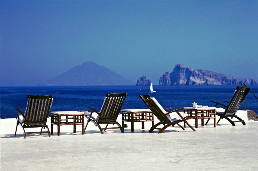 Lounges chairs in Aeolian Islands looking at Mt Etna in Sicily