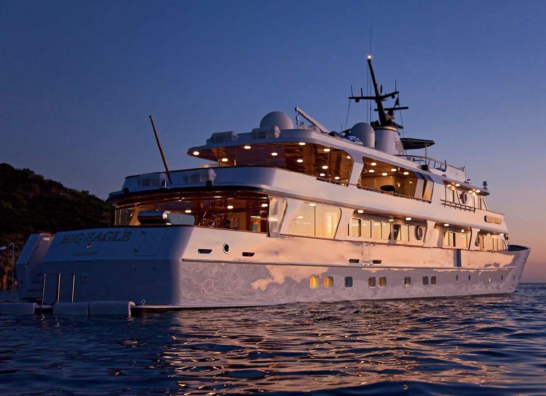 172' motor yacht BIG EAGLE's aft deck at sunset with evening lighting