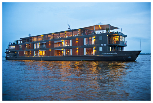 AQUA MEKONG exterior with lights on at twilight cruise on the Mekong River