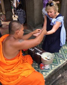 Carol blessed by a Buddhist monk at Angkor Wat, Cambodia