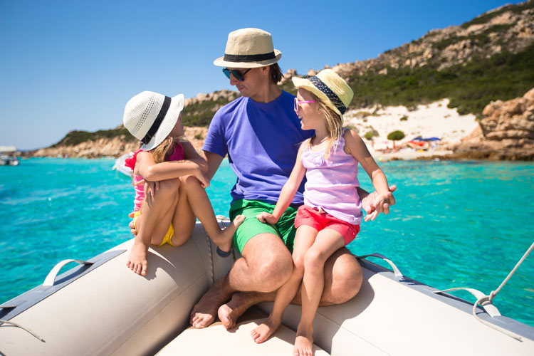 Young father with adorable girls resting on big boat New Year's resolution