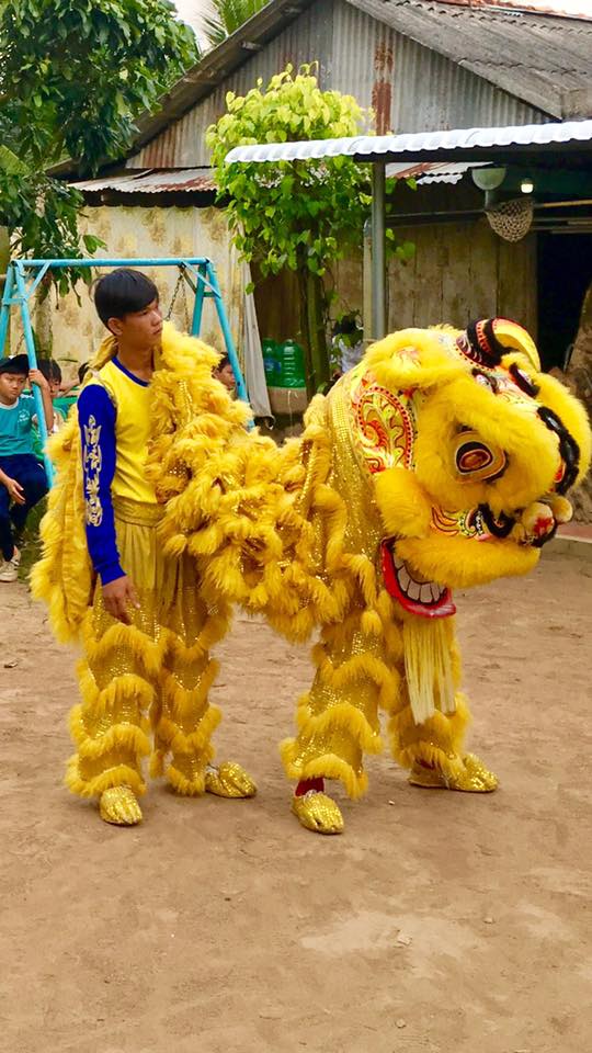 Boy dressed in golden lion costume in Cambodian parade New Year's Resolutions