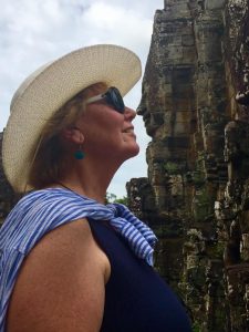 Carol nose-to-nose with a stone sculpture at Angkor Wat, Cambodia