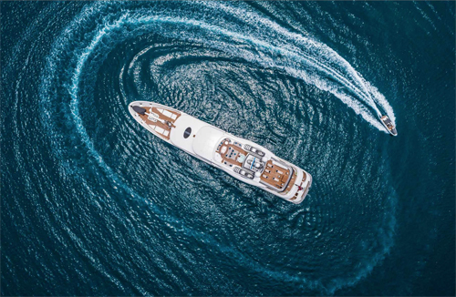 Motor yacht CALYPSO M-Y w Circling Tender Aerial View