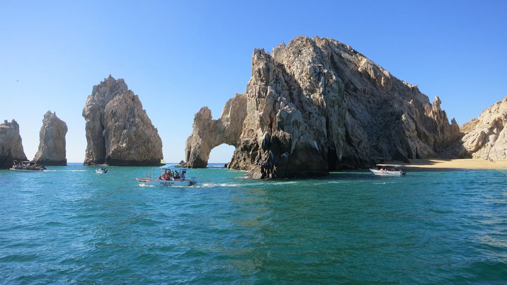 Stone arch in Cabo, Mexico with shuttle boat