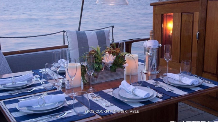 Sailing yacht EROS cockpit dinner table with place settings and candles