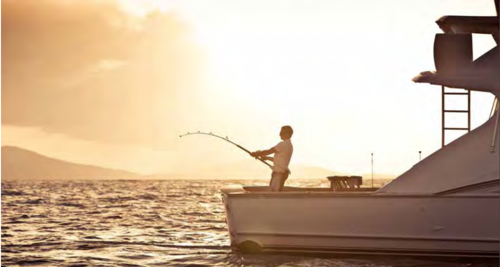 Man fishing off the 145' sailing yacht Hemisphere