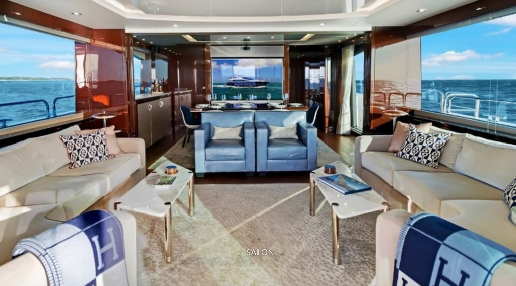 Salon with blue chairs and TV on the 86ft motor yacht Enterprise