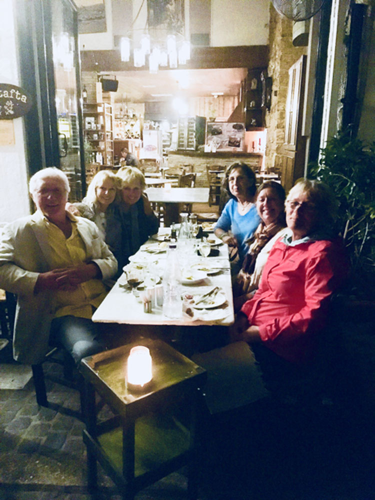 FAM trip guests at dinner table in Greece