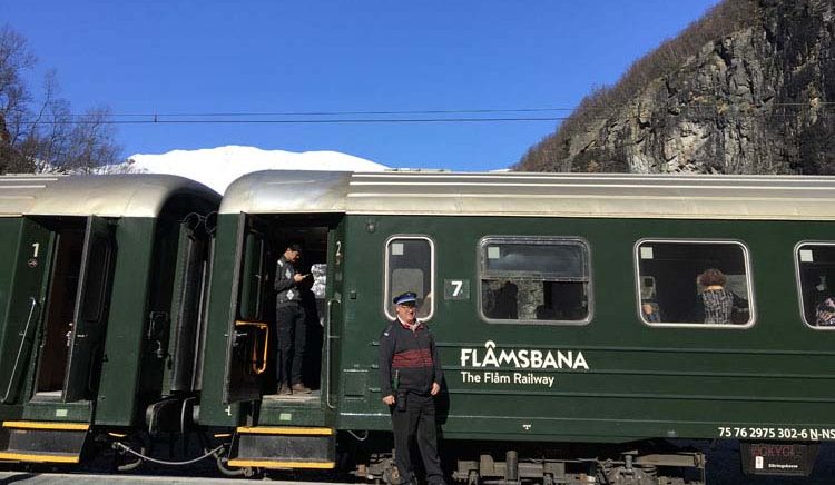 Flambana railway car with proud engineer on the Flam Railway in Norwegian fjords, Norway