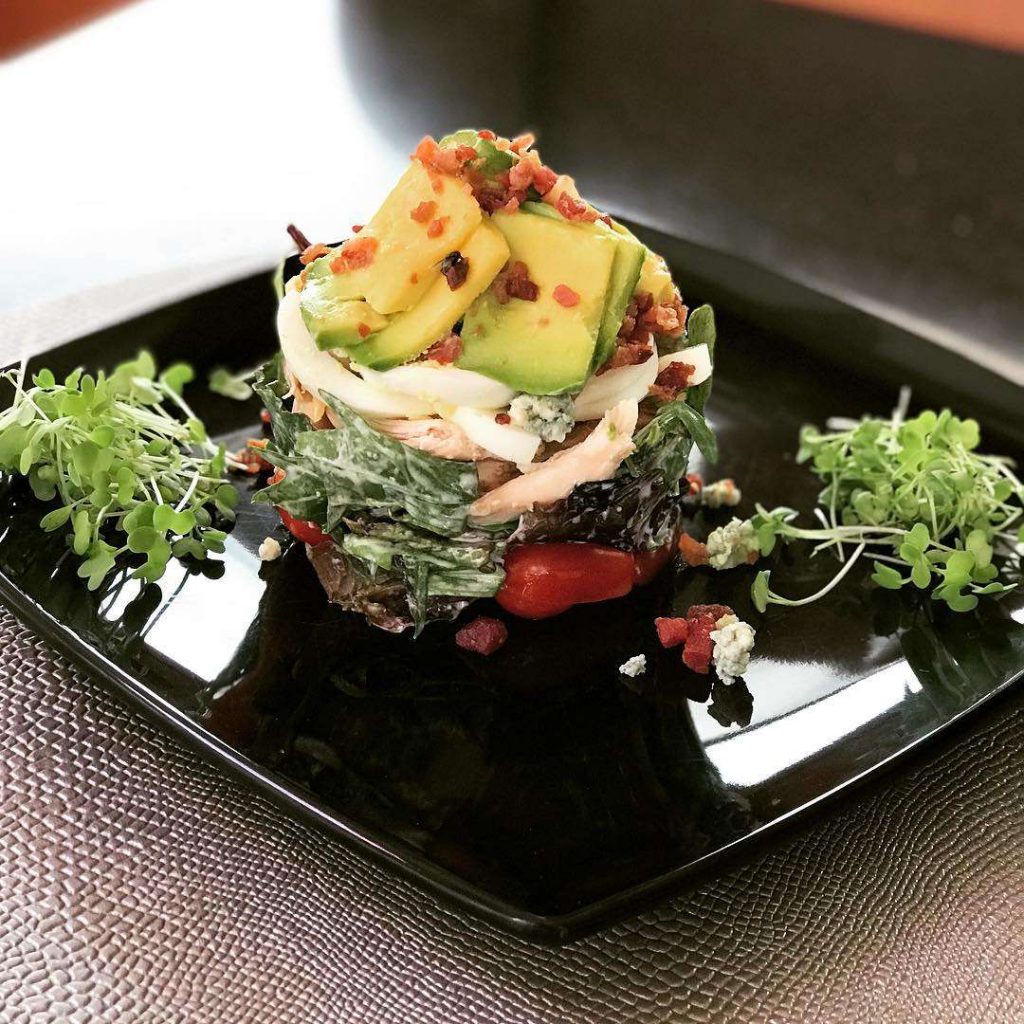 Chef Jen's Grilled Jumbo Shrimp with Avocado & Pineapple Salsa Tower Salad is a favorite dish on her 46ft catamaran