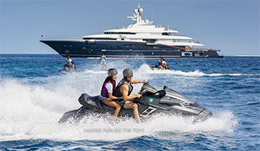 Couples on jet skis playing off 290ft Oceanco superyacht NIRVANA