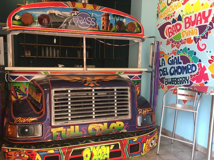Smoothie bar uses colorful revamped school bus as store front in Panama