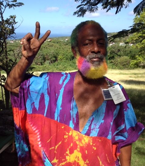 St. Barts native with matching beard and shirt flashes a peace sign