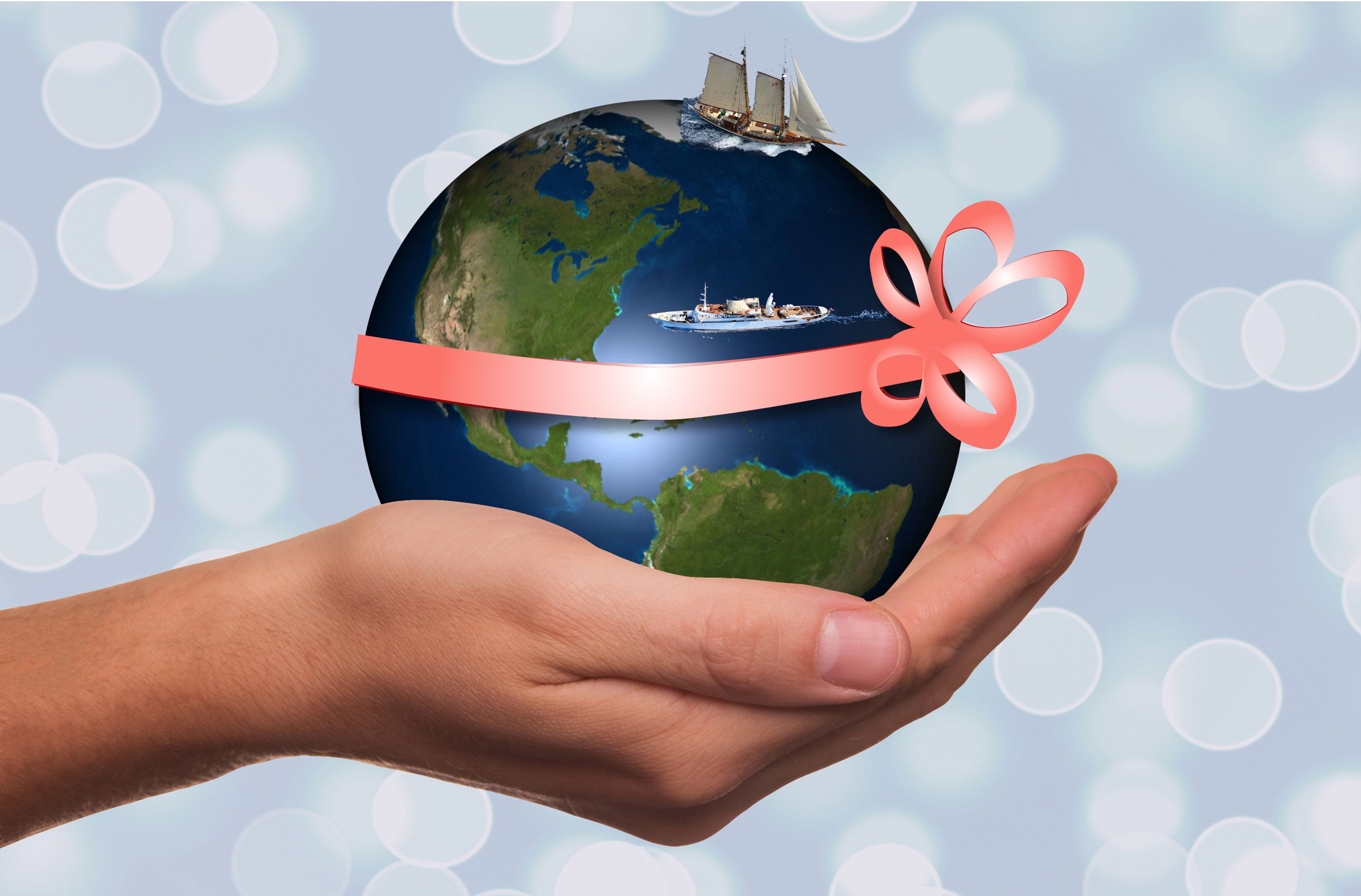 Earth with sailboat and motor yacht with coral ribbon in a hand for gift certificate