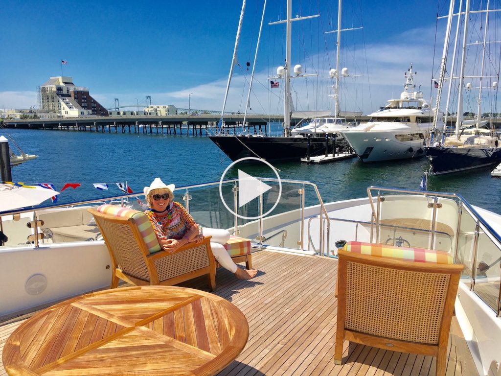 Carol Kent, President of Carol Kent Yacht Charters International, in a comfy chair on board a yacht deck in Newport, Rhode Island where she is vetting boats. Link to YouTube Channel
