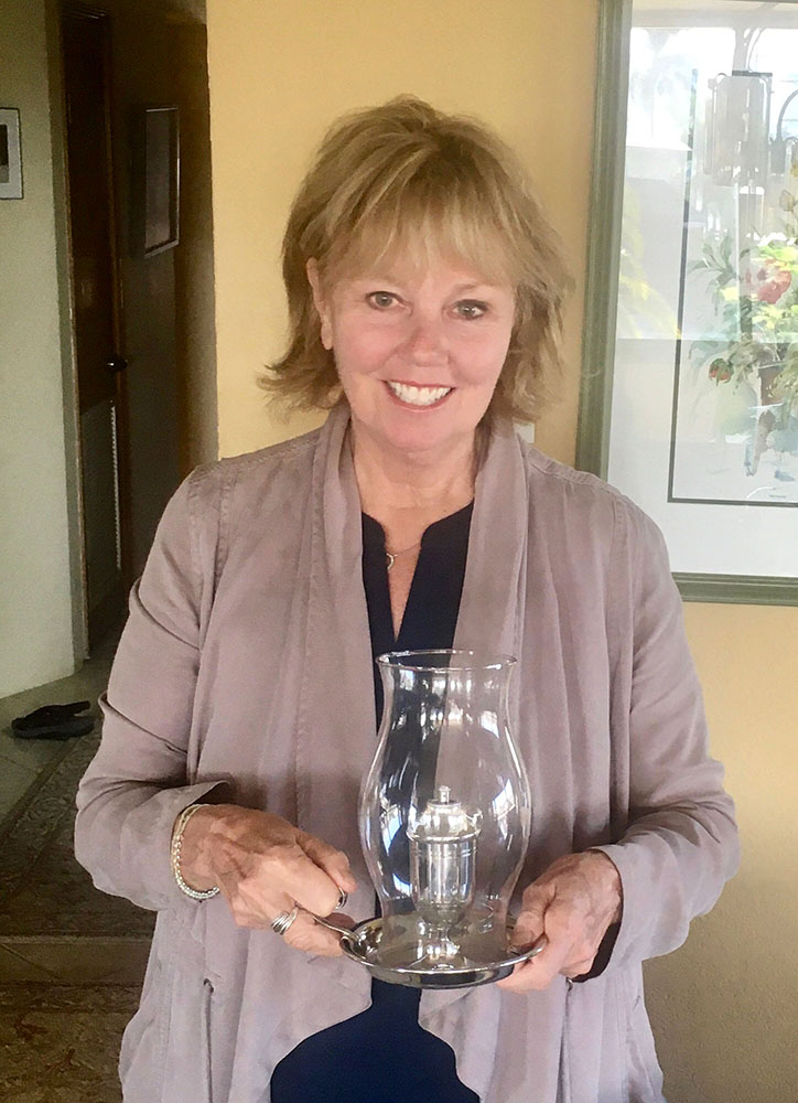 Carol Kent, outgoing President of the American Yacht Charter Association, holding the lantern gifted to her for her service, 2020-22