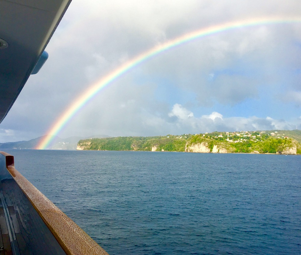 Rainbow from yacht deck over cliffs in St. Lucia, British Virgin Islands