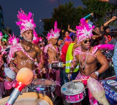 Men with pink feathers and drums at Martinique Carnival night party. Photo©Carnivaland.net