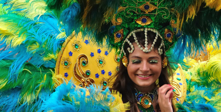 Woman in feathers at Vincy Mas Festival in St. Vincent and the Grenadines. Photo courtesy of officeholidays.com