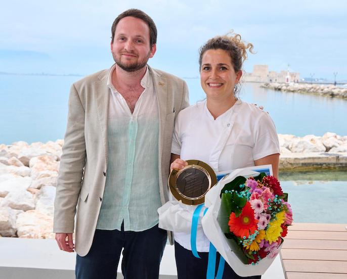 Tatiana Konstantidi of M-Y HAKUNA MATATA with judge after taking First Place Winner in the MEDYS Chefs' Competition 2023 in Napflion, Greece