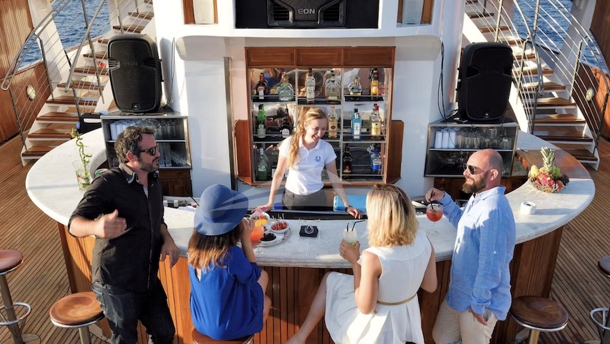 Outside bar and bartender on 325ft Canadian Vickers motor yacht CHRISTINA O