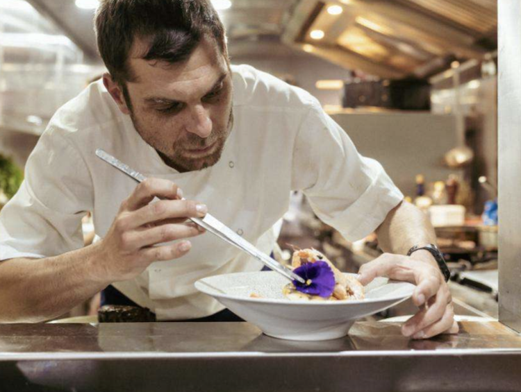 Chef on 172ft Croatia-based motor yacht SYMPHONY add edible flower to seafood dish